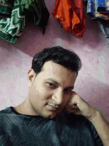 a man laying down with his hand on his chin looking down