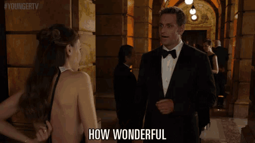 a man in a tuxedo stands next to a woman in a dress and says " how wonderful "