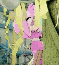 a pink stuffed animal is hanging from a tree with yellow ribbons