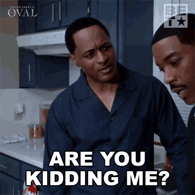 two men are standing in a kitchen and one of them is saying " are you kidding me ? "