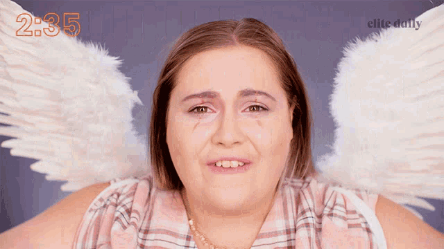 a woman with white angel wings and the time 2:35