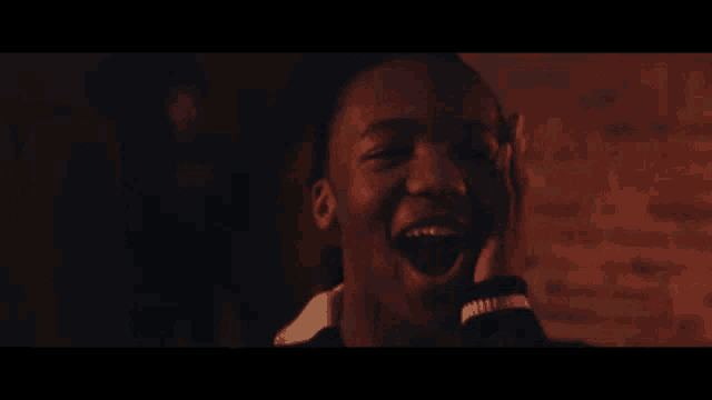 a close up of a man laughing with his mouth wide open