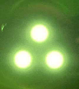 a green background with three circles of light