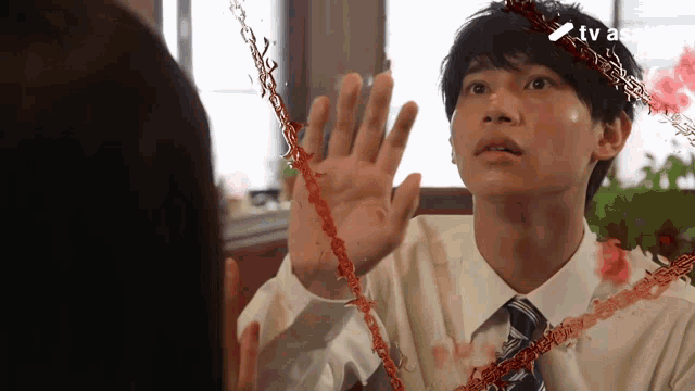 a man in a white shirt and tie with a tv asahi logo on the bottom right