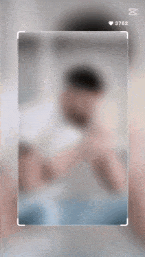 a blurred image of a person with the number 3762 on the bottom right