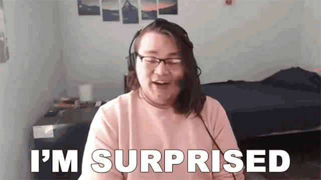 a woman wearing glasses and headphones is sitting in front of a camera and says `` i 'm surprised ''