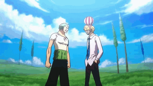 two men are standing next to each other in a grassy field .