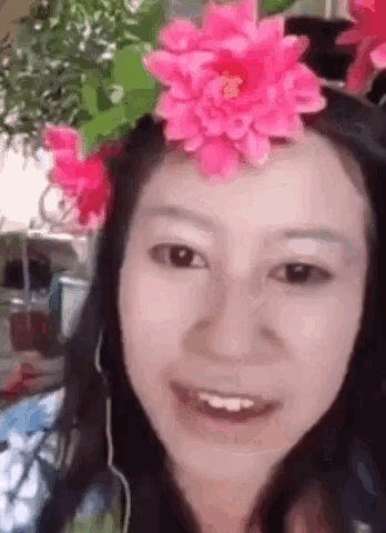 a woman wearing a flower crown on her head .