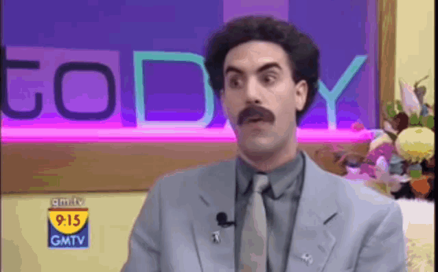 a man in a suit and tie is on gmtv