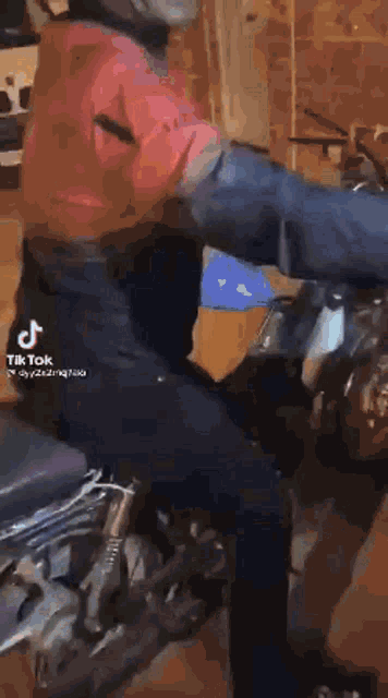 a blurred image of a person with a tik tok logo on the bottom