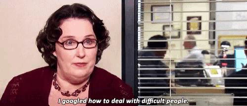 a woman wearing glasses and a necklace says " i googled how to deal with difficult people "