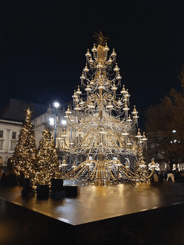 a large christmas tree with lots of lights and a star on top