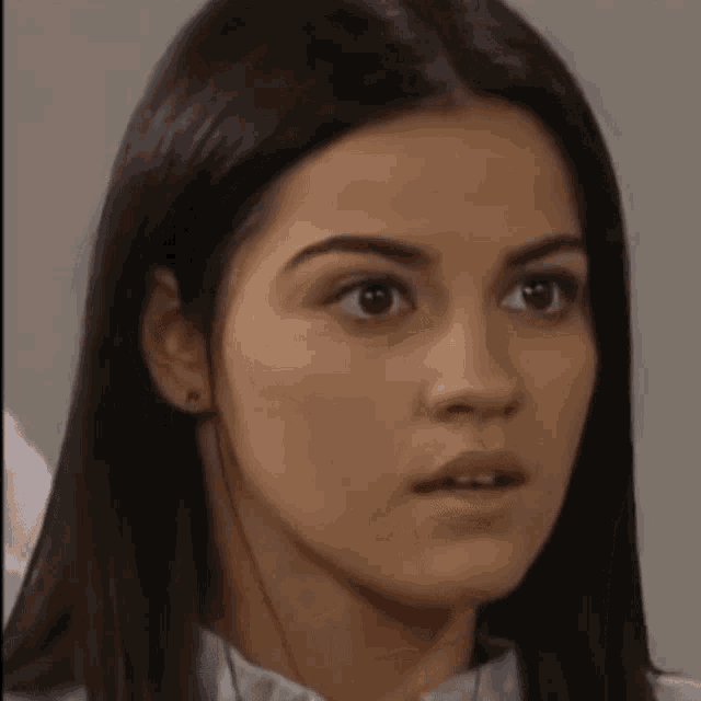 a close up of a woman 's face with a surprised expression .