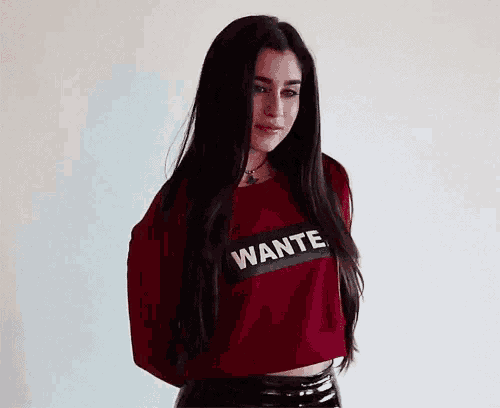 a woman is wearing a red sweater that says wante on it