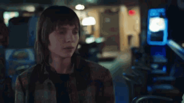 a blurry picture of people walking in a dark room at night