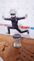 a figurine of a man jumping in the air is sitting on top of a hourglass .