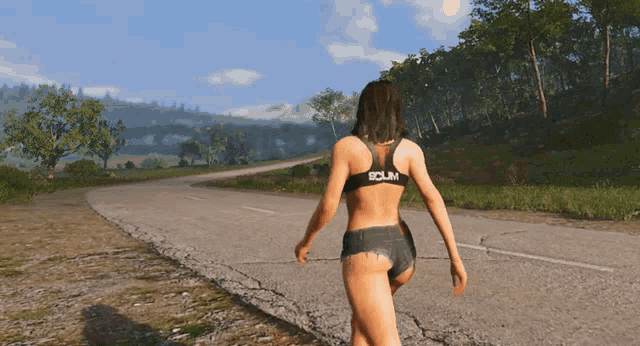 a woman walking down a road wearing shorts and a sports bra that says scum