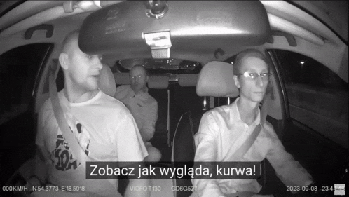 a black and white photo of three men in a car with the words zobacz jak wygląda kurwa at the bottom