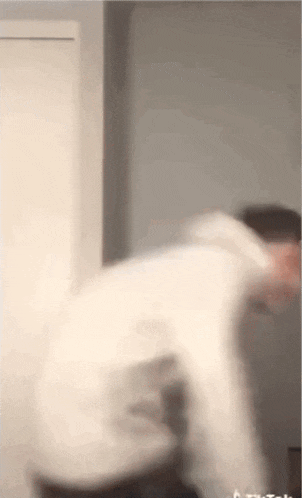 a blurry picture of a man standing in front of a window .