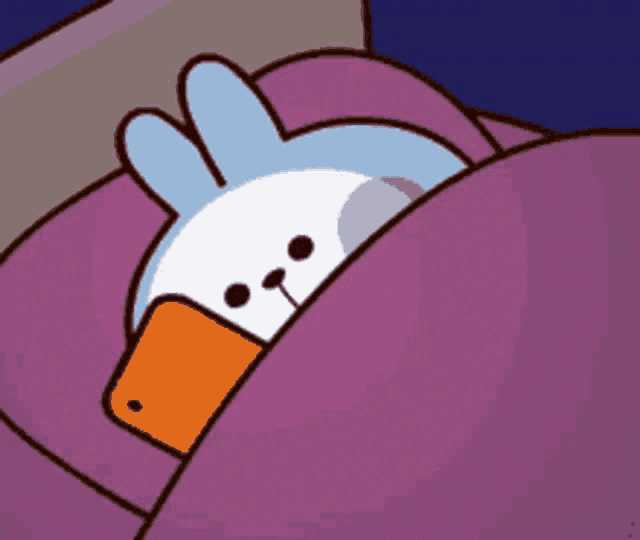 a cartoon rabbit is sleeping in a bed with a cell phone in its mouth