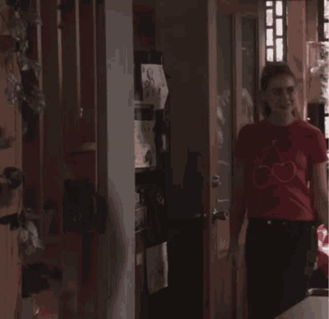 a woman wearing a red t-shirt with a cherry on it