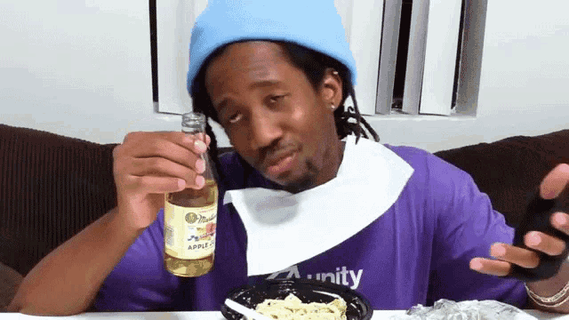 a man in a purple shirt that says unity