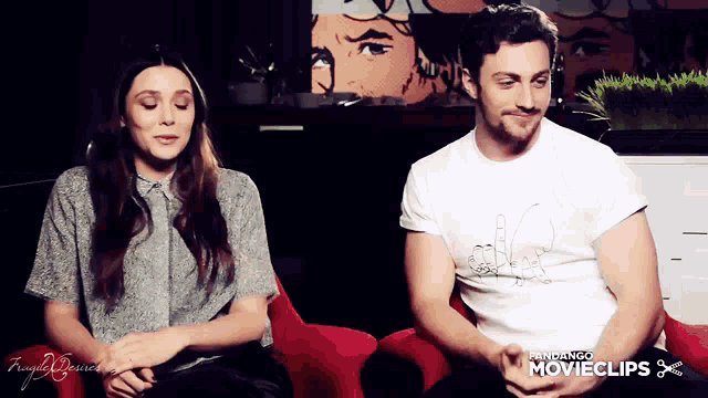 a man and a woman are sitting next to each other and the man is wearing a white shirt that says movieclips