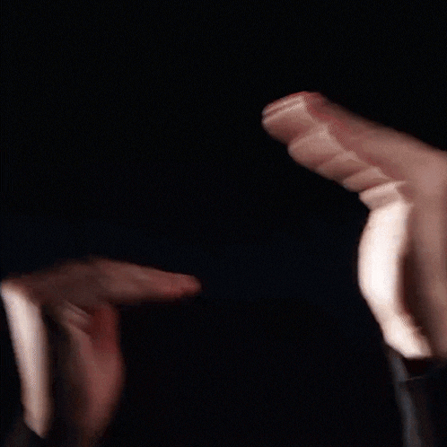 a close up of a person 's hands making a triangle shape