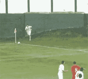 a blurry picture of a soccer field with players in red and white jerseys