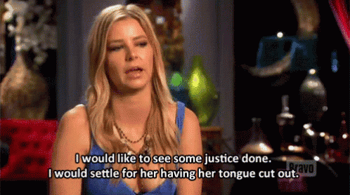 a woman in a blue tank top is talking about justice