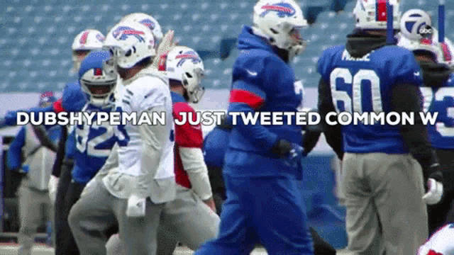 a group of buffalo bills players walking on a field with the caption dubshypeman just tweeted common w.