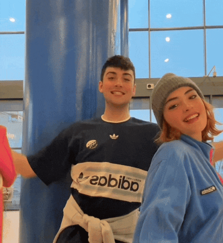 a man and a woman are posing for a picture with the man wearing a shirt that says ebbibb