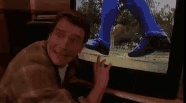 a man is looking at a tv screen with a picture of a person on it