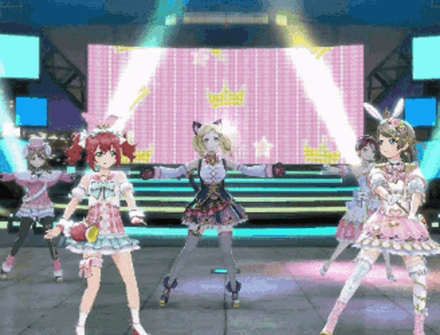 a group of anime girls are standing on a stage