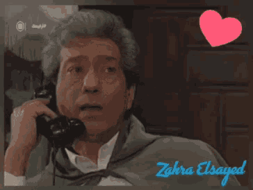 a picture of a man talking on a phone with the name zahra elsayed written on the bottom