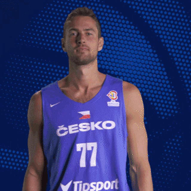 a man wearing a purple jersey with the letter b on it making a funny face