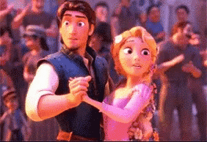 a man and a woman are dancing in front of a crowd of people .