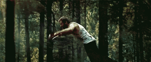 a man is doing a handstand in the woods .