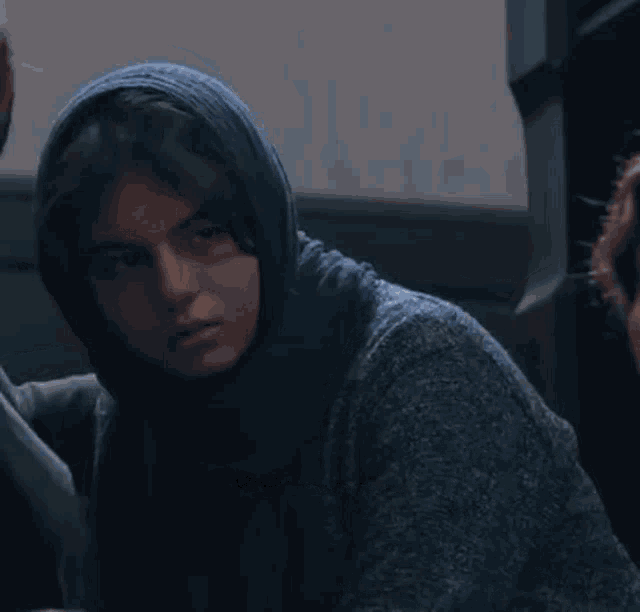 a woman wearing a head scarf and a blue sweater has the hashtag @koksalgif on the bottom right