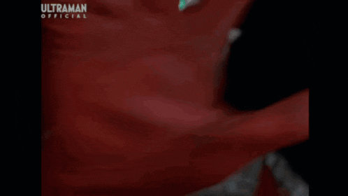 a close up of a cartoon character with glowing eyes and the word ultraman on the bottom