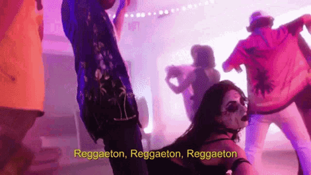 a group of people are dancing in a dark room with the words reggaeton in the corner