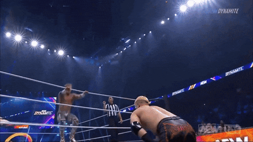 a man in a wrestling ring with #aew dynamite written on the screen