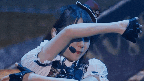 a woman with a microphone on her head is covering her eyes
