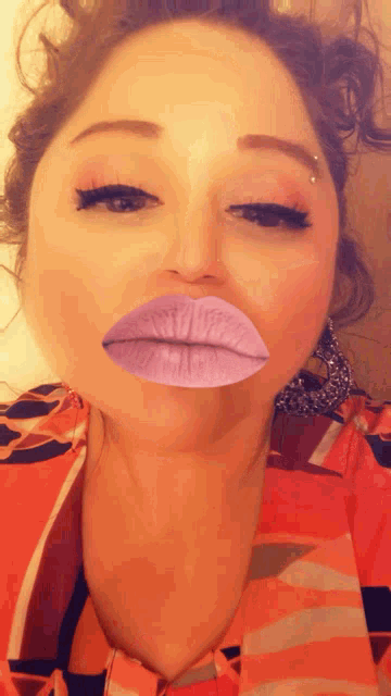 a woman with purple lips is wearing earrings