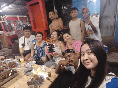 a group of people posing for a picture including a man wearing a shirt that says ' i love you ' on it