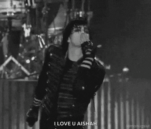 a black and white photo of a man holding a microphone and saying `` i love u aisha '' .