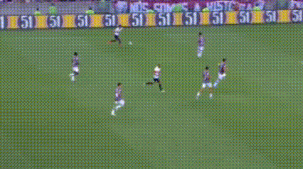 a soccer player is kicking a soccer ball on a soccer field .