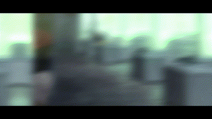 a blurry picture of people walking down a street