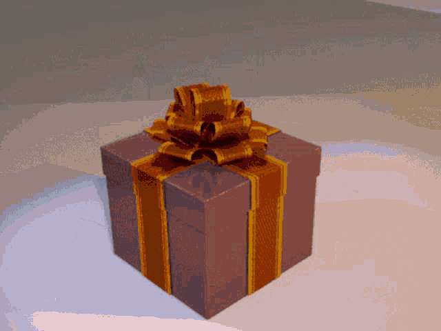 a gift box with a gold bow on it