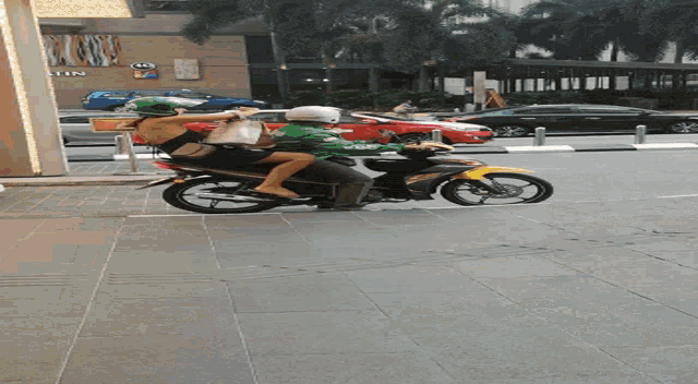 a person riding a motorcycle in front of a building that says ' n'tlin ' on it